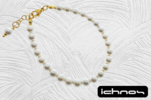 Bracciale perle mm. 6 con chiusura acciaio e catenina di regolazione dorate